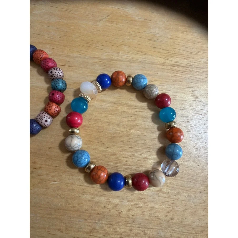 Set of 2 Multi Color Beaded Stretch Bracelets  Silver Wing Charm